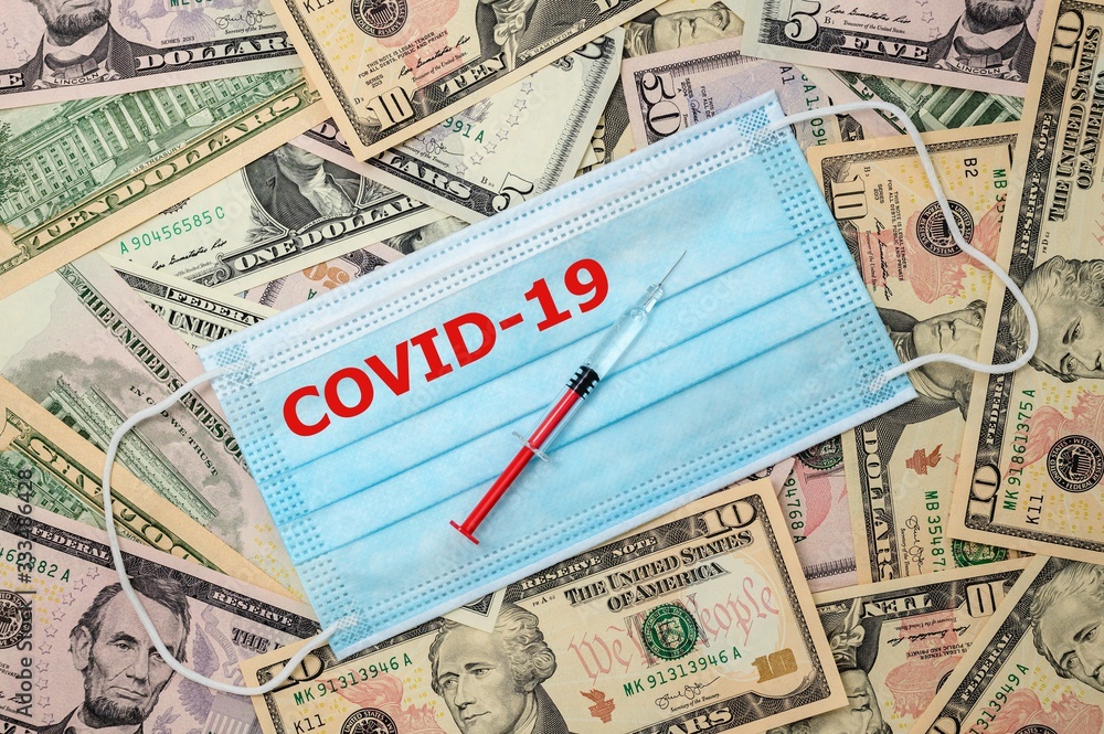 Medical viel laid on US dollars. Syringe are placed on the veil. Medical viel laid on US dollars. Syringe are placed on the veil.