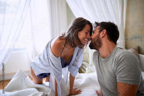 Female and male in love share tenderness in bed