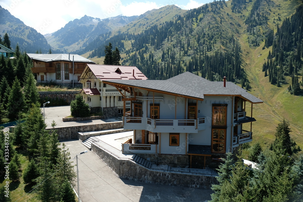 Several guest summer houses among firs and trees in the mountainous area