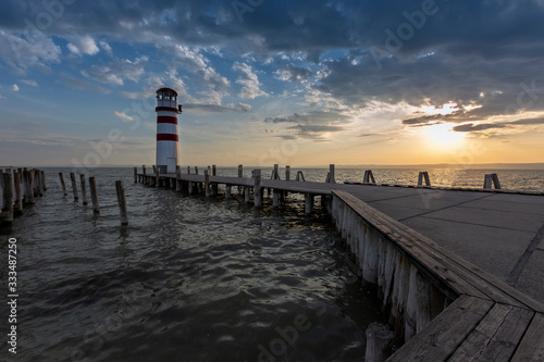 Lake Neusiedl - Pier leading to the Lighthouse on the lake. Standing stakes on the left in the water to hold boats.