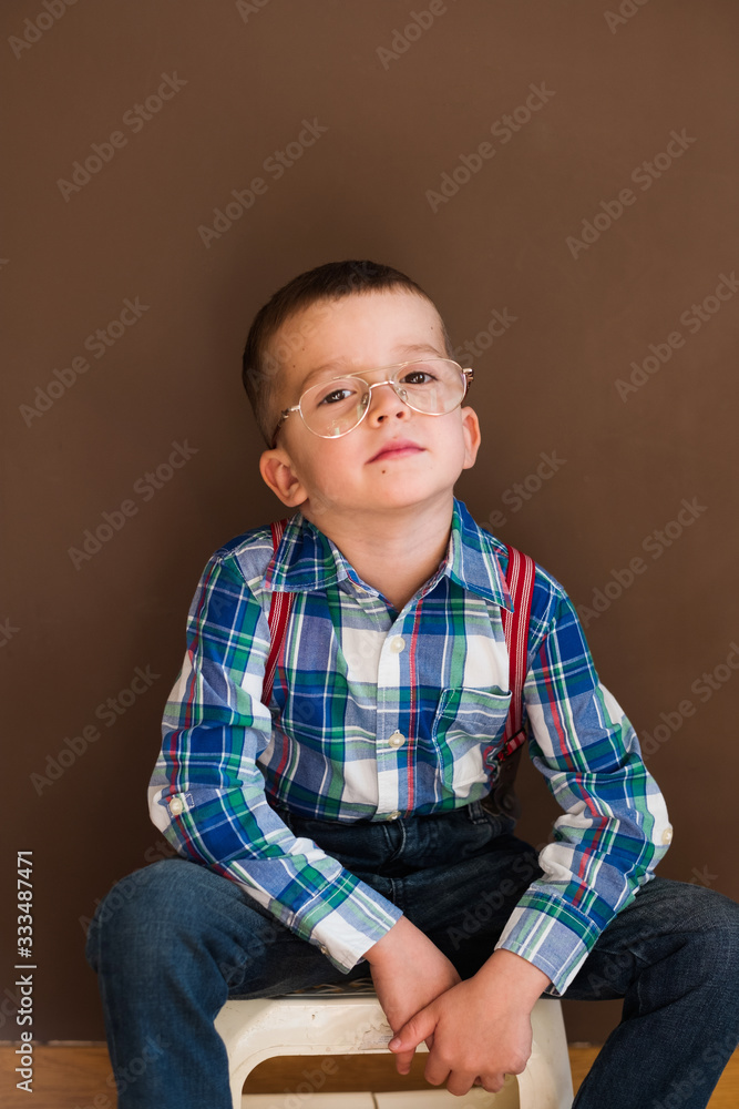 Young handsome kid smiling with blue shirt and suspenders Young handsome kid smiling with blue shirt and suspenders