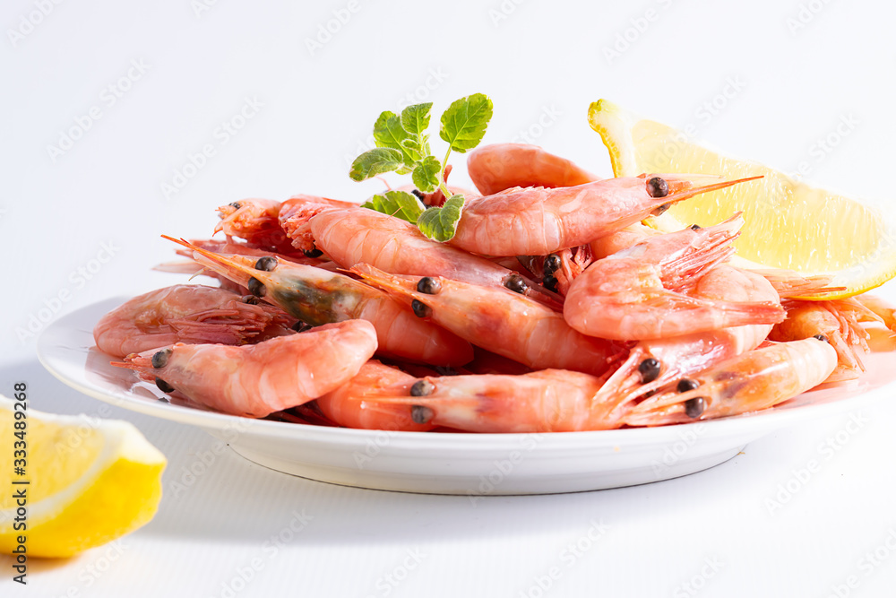 Fresh boiled shrimps with lemon and spices on dark stone background with copy space for your design. Sea food concept. Healthy diet food. Fresh boiled shrimps with lemon and spices on dark stone background with copy space for your design. Sea food concept. Healthy diet food.
