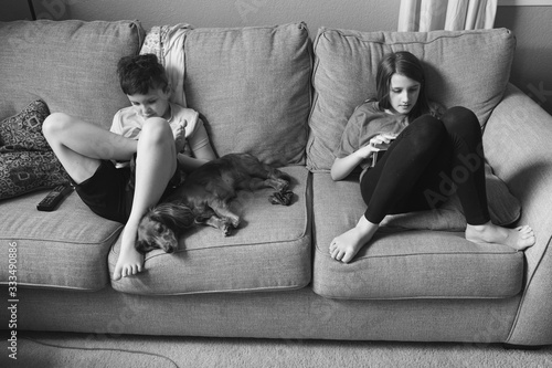 brother sister and dog screen time on couch 