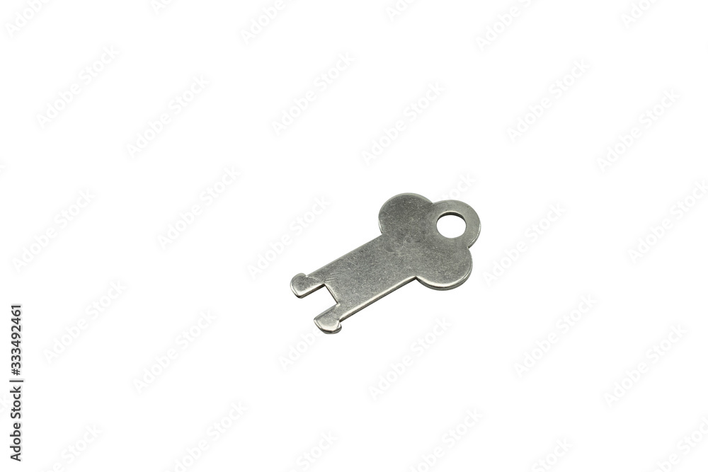 A silver, antique luggage key, close up, isolated on a clean, white background. Shot in macro. A silver, antique luggage key, close up, isolated on a clean, white background. Shot in macro.