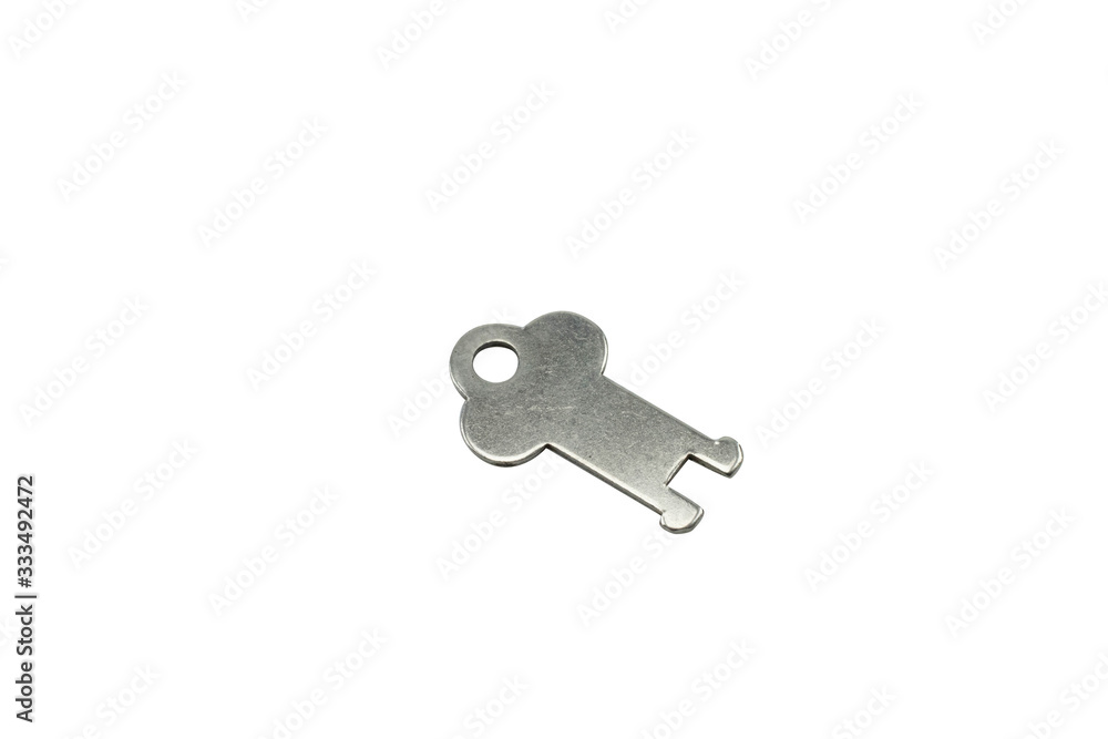 A silver, antique briefcase key, close up, isolated on a clean, white background. Shot in macro. A silver, antique briefcase key, close up, isolated on a clean, white background. Shot in macro.