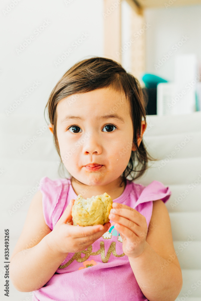 Toddler Girl Eating Banana Muffin Toddler Girl Eating Banana Muffin