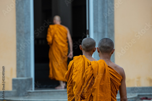 Buddhist monks going inside the temple. Bagkok, Thailand