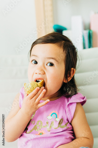 Toddler Girl Eating Banana Muffin