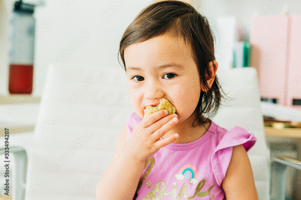 Toddler Girl Eating Banana Muffin Toddler Girl Eating Banana Muffin