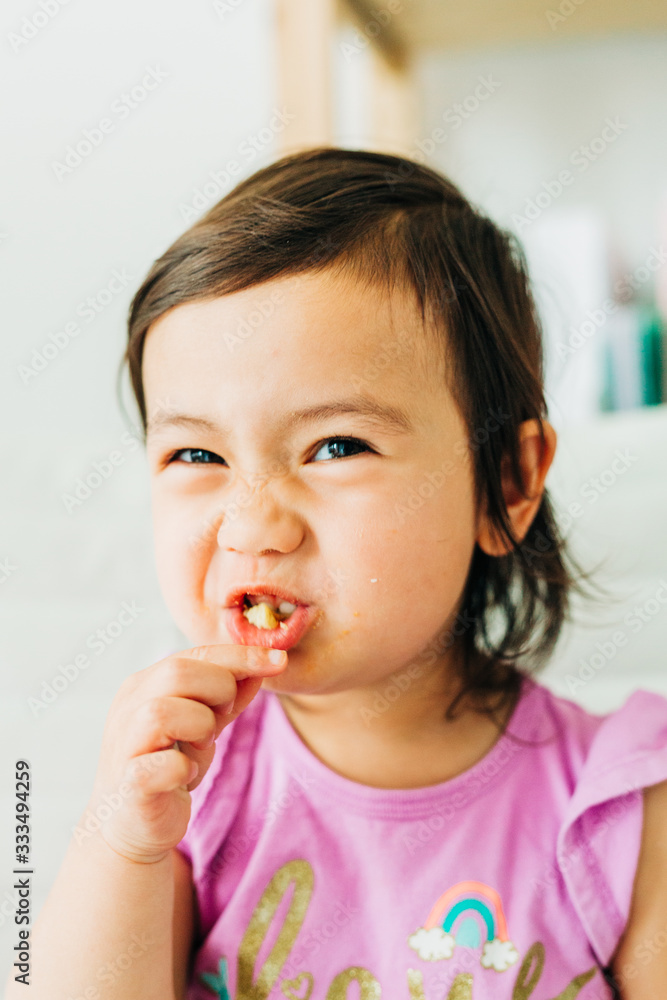 Toddler Girl Eating Banana Muffin Toddler Girl Eating Banana Muffin