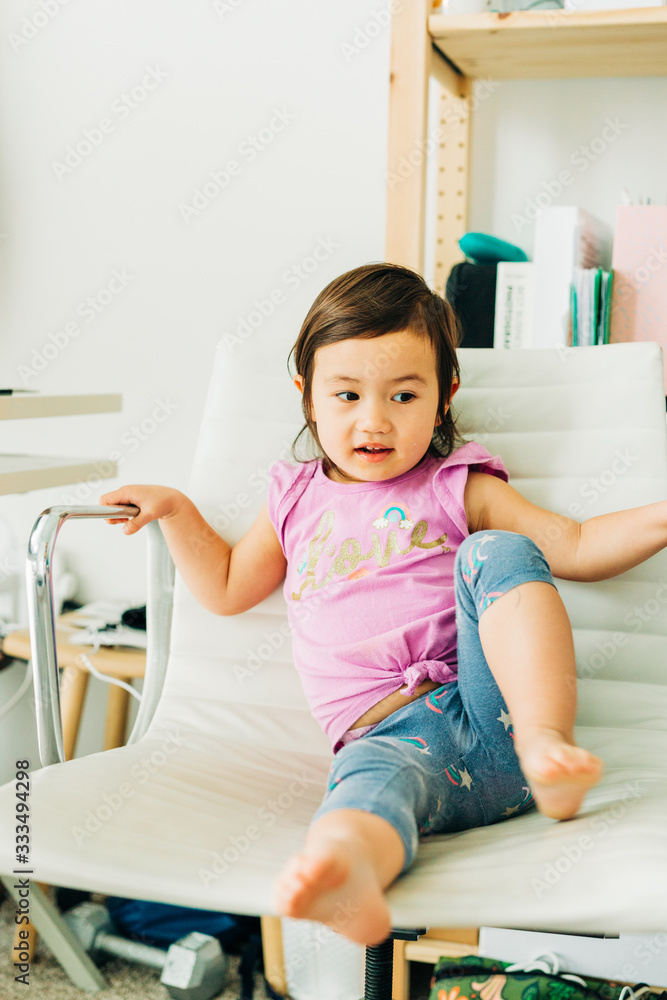 Fototapeta premium Toddler Girl Eating Banana Muffin