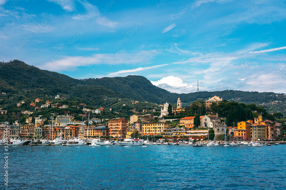 Fototapeta premium Scenic view of Santa Margherita Ligure on the Italian Riviera overlooking the Gulf of Tigullio. Beautiful mediterranean landscape with cloudy blue sky on sunny day.
