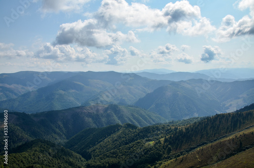 Aerial view above in the mountains and meadows. Beautiful landscape on a summer day. Carpathian of Ukraine. Holidays in the mountains.