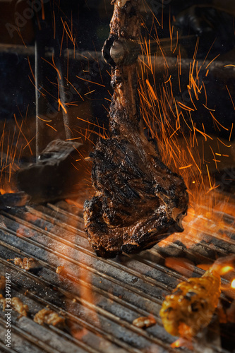 dry aged tomahawk and garnishes photo