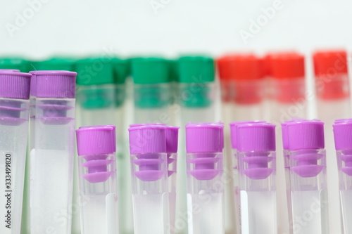 purple and red and green blood collection tubes in the middle Blur the back White background