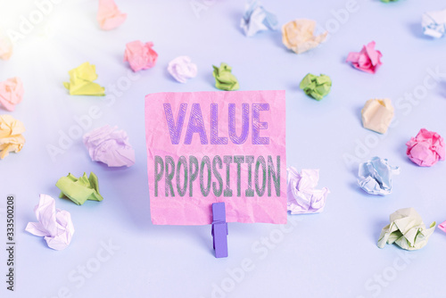 Conceptual hand writing showing Value Proposition. Concept meaning feature intended to make a company or product attractive Colored crumpled papers empty reminder blue floor clothespin