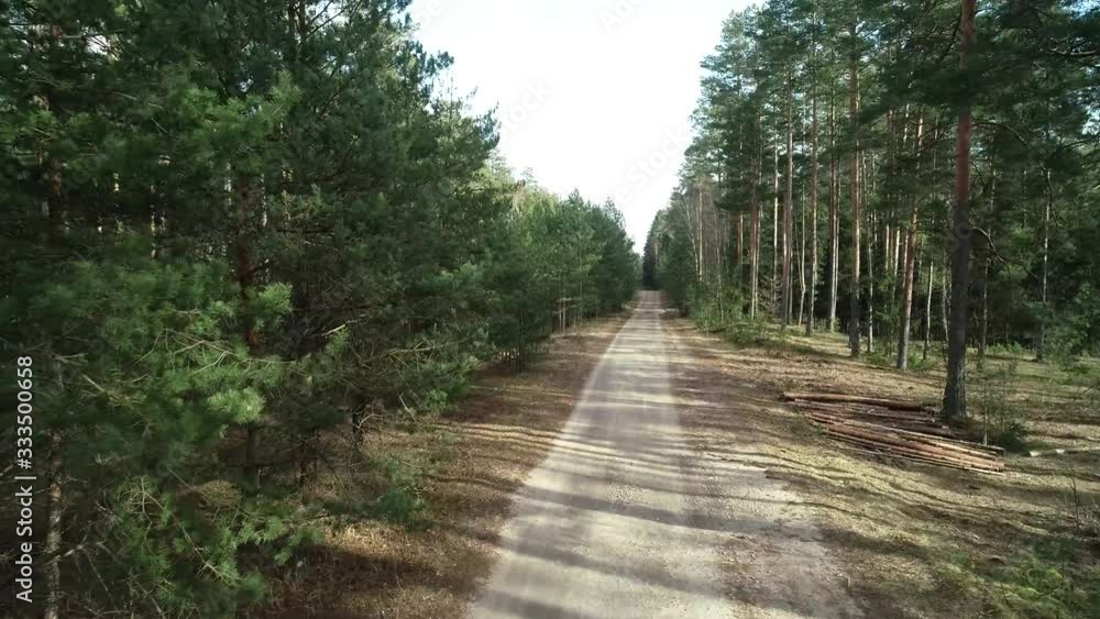 Country road in middle of forest above drone view in summer time Country road in middle of forest above drone view in summer time