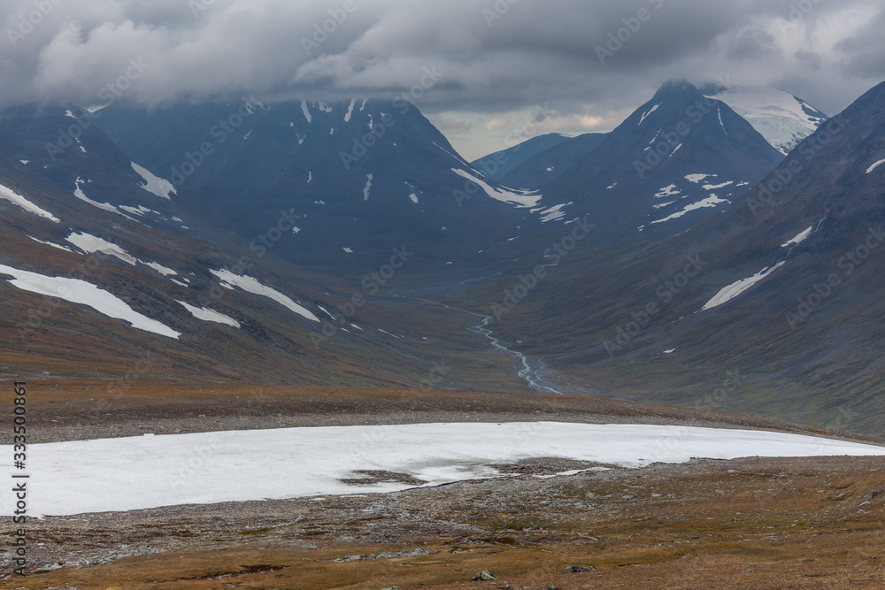 View of the valley. Northern Sweden, Sarek National Park in stormy weather. selective focus View of the valley. Northern Sweden, Sarek National Park in stormy weather. selective focus