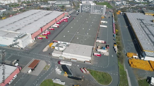 Rosbach, Germany - March 27, 2020: Aerial view of large distribution center of REWE and PENNY. The REWE Group is a German diversified retail and tourism co-operative group. photo