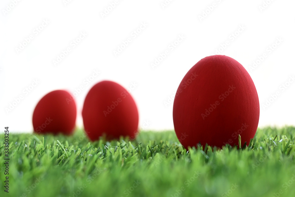 red easter egg on lawn green grass artificial with blank white background red easter egg on lawn green grass artificial with blank white background
