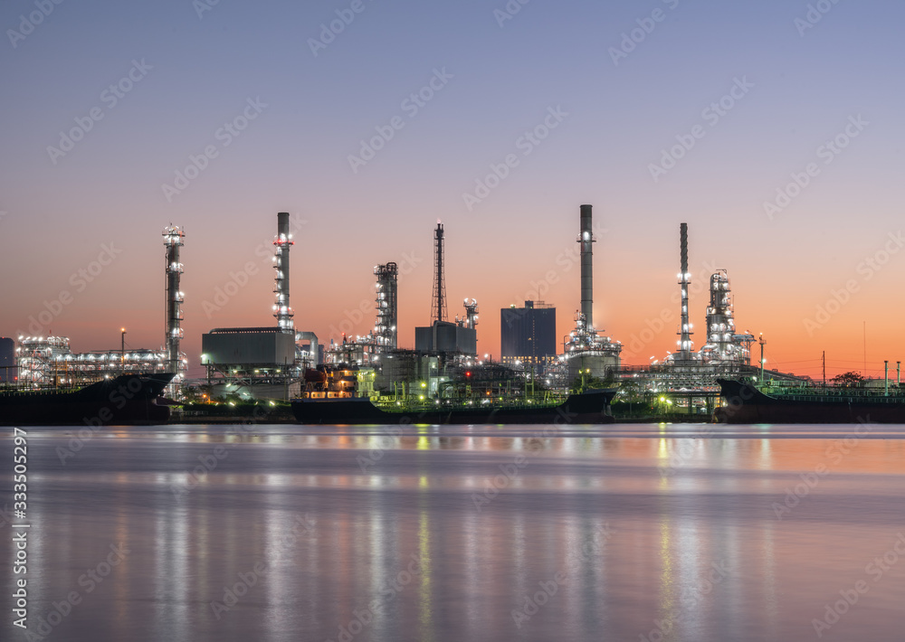 Petrochemical industry factories and oil refineries, natural gas storage tanks industry, along with the sunset sky, oil transportation by boat