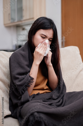 Portrait of a sneezing and sick flu young woman asian at home. Pandemic 2019 Coronavirus 2019-nCoV Concept.
