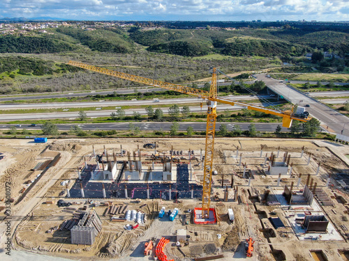 Aerial view of investors and contractors on construction site with crane. New construction site with crane and building materials. San Diego  California  USA. March  26th  2020 