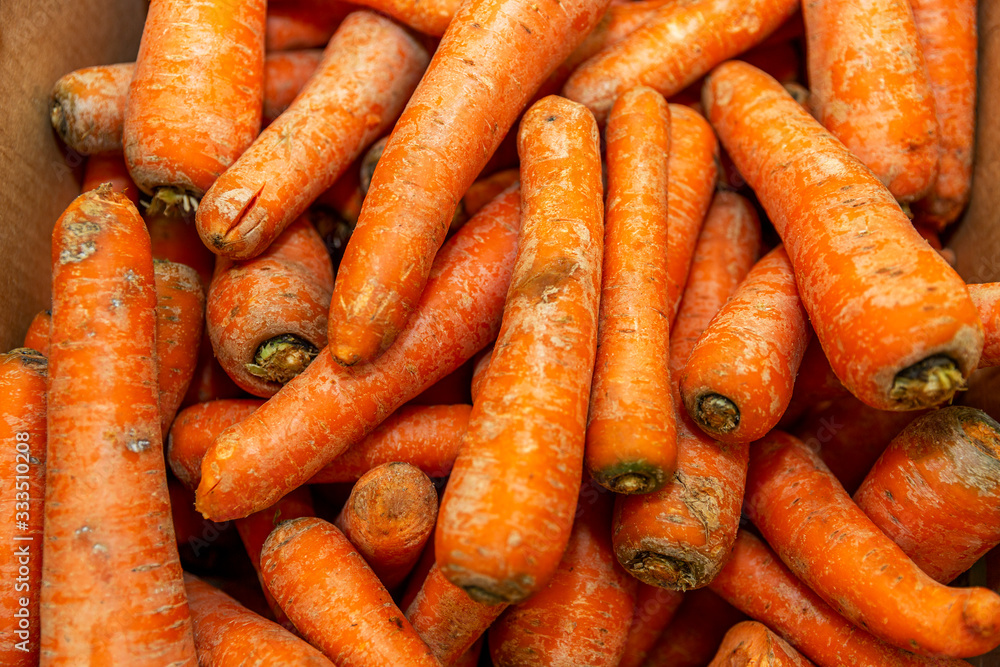 Fresh carrots on a store counter. Healthy nutrition and vitamins. Close-up. Fresh carrots on a store counter. Healthy nutrition and vitamins. Close-up.