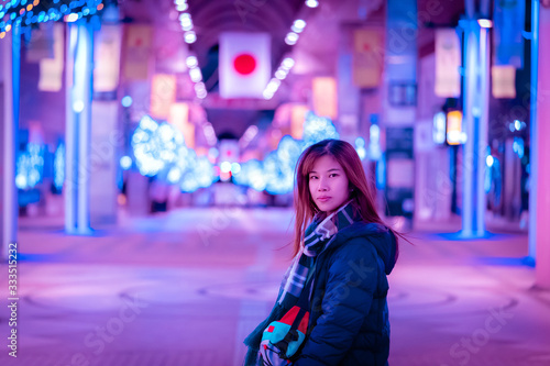 Beautiful Woman portrait in winter fashion clothing at night in The Jozenji christmas light up festival in Sendai, Japan photo