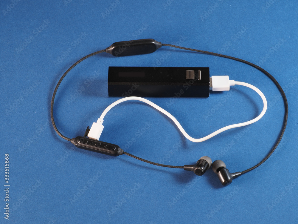 Wireless headphones are charging from power bank