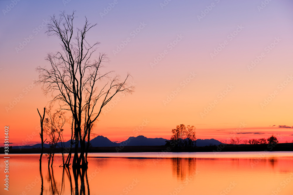 Amazing sunset landscape of a peacfel mountain lake in the evening.