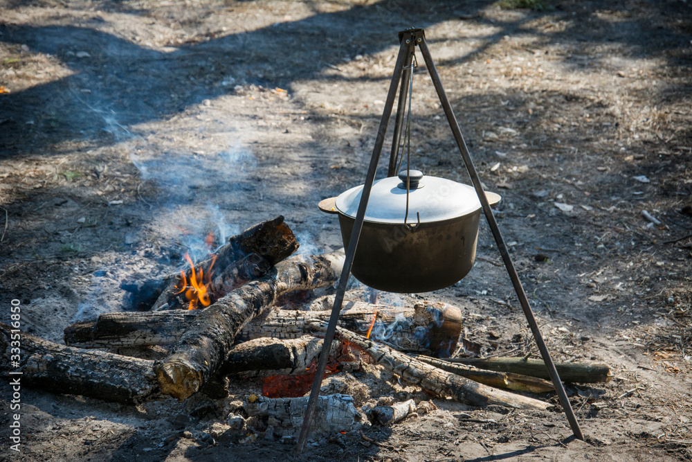 In the summer, in the woods at the stake in the pot, food is prepared. In the summer, in the woods at the stake in the pot, food is prepared.