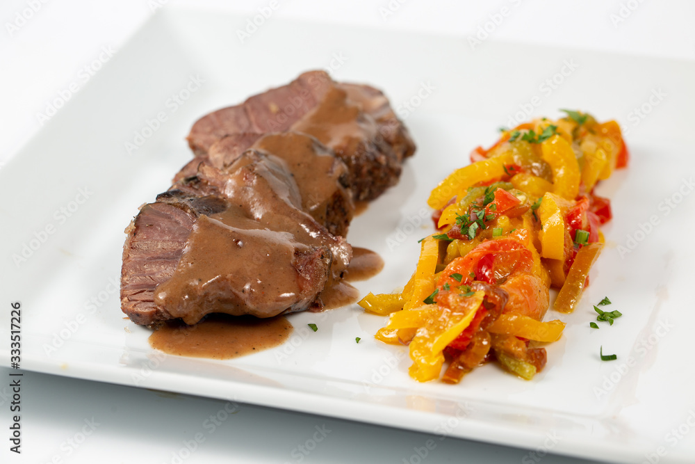 Veal shank with colored peppers