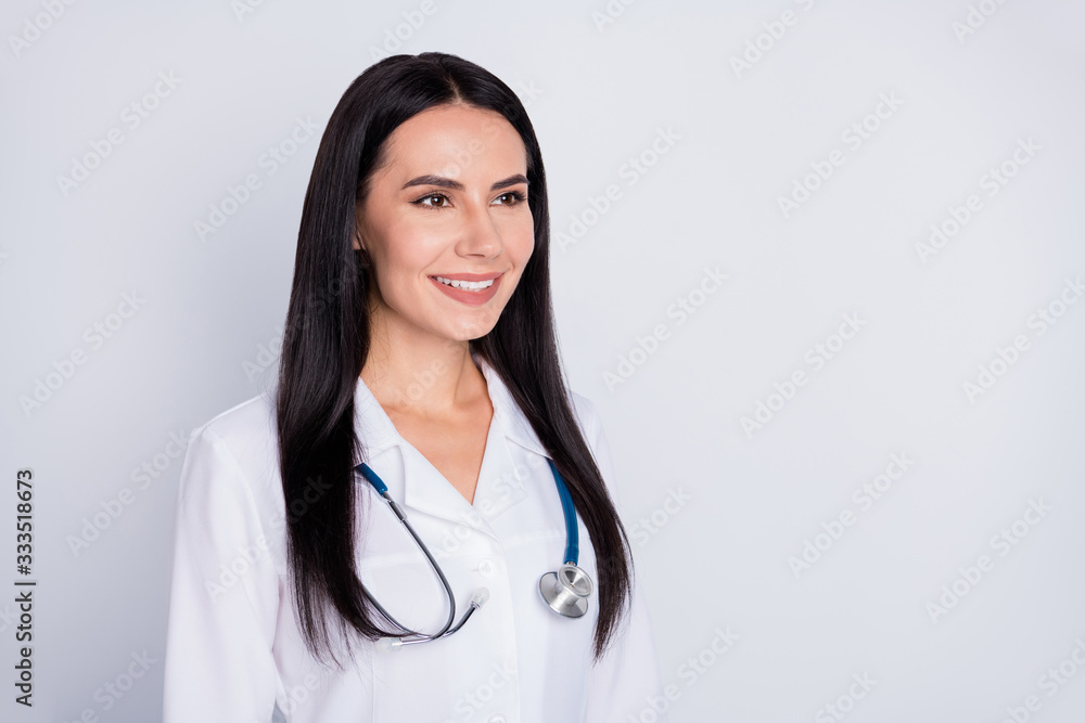 Photo of attractive professional doctor practitioner intern lady good mood friendly smiling looking patient wear white lab coat stethoscope isolated grey color background Photo of attractive professional doctor practitioner intern lady good mood friendly smiling looking patient wear white lab coat stethoscope isolated grey color background