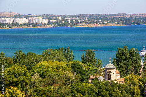 beautiful summer landscape with sea views and an ancient Byzantine temple among the green foliage of trees