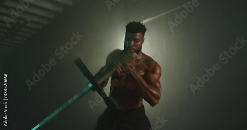 Man working out in dark gym