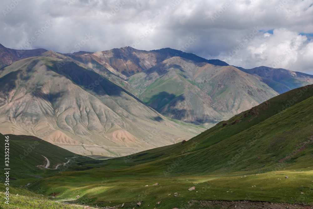 Green slopes of mountains and wide valley. Kyrgyzstan. Green slopes of mountains and wide valley. Kyrgyzstan.