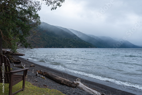 Landscape of shoreline and mountains surrounding Lake Crescent on a cloudy day in Olympic National Park in Washington