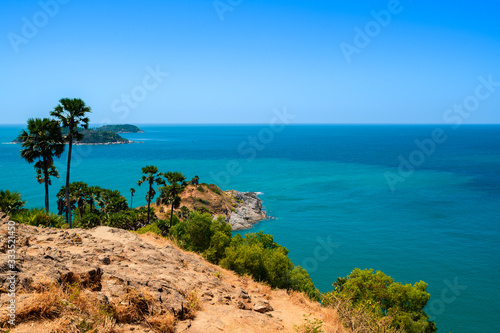 View of the sea, blue sky and palm trees at Promthep Cape in Phuket, southern Thailand. © Chaiyuth