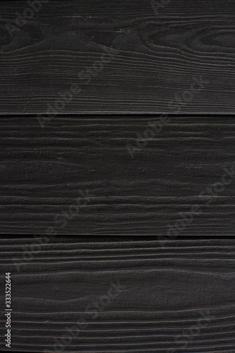 Black embossed wood texture. Dark wooden background. Wood texture close up. Wood planks.
