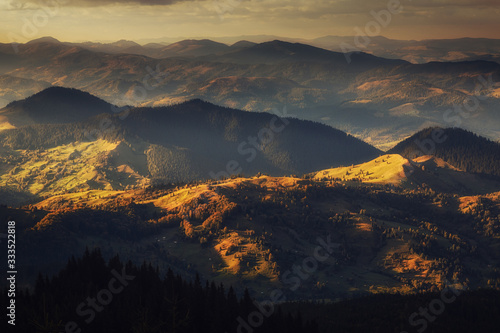 Mountain peaks at sunset. Panorama of mountain chain from a top view