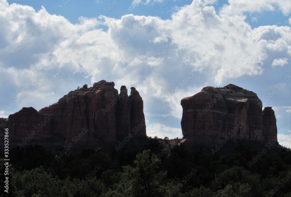 Silhouette of Cathedral Rock in Sedona, Arizona with clouds and blue sky in the background 
