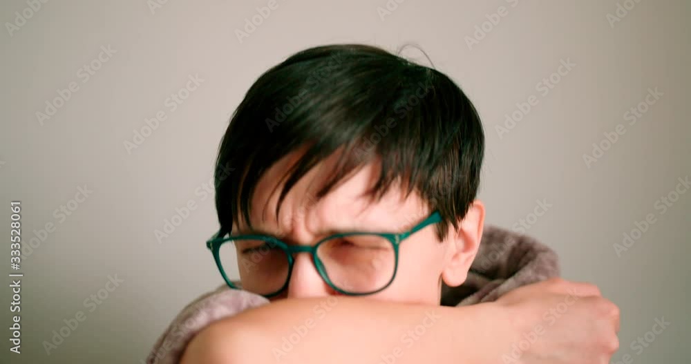 Close up view of a mid ages lady sneezing and coughing to elbow.Safe way to avoid spreading illness. Close up view of a mid ages lady sneezing and coughing to elbow.Safe way to avoid spreading illness.