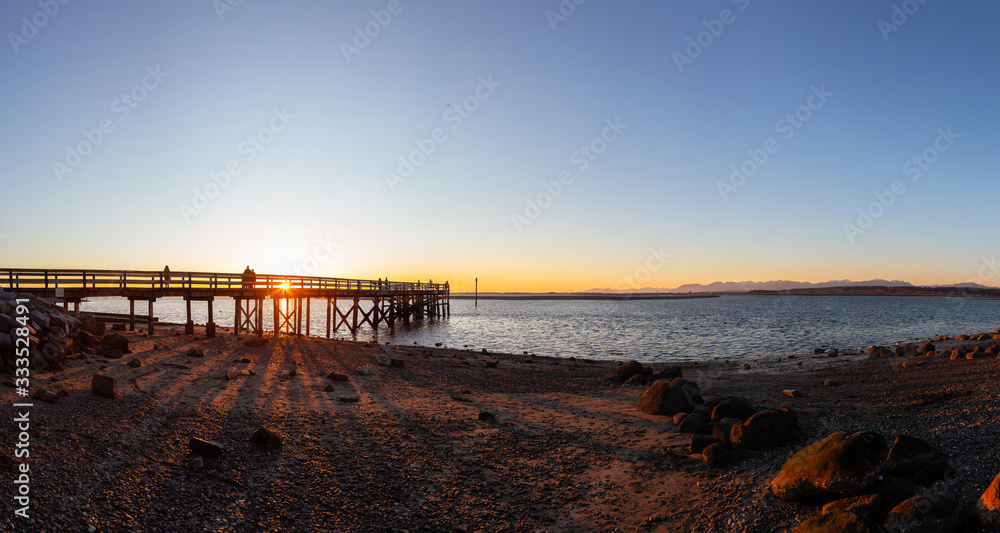 Beautiful Panoramic View of a park by the Pacific Ocean Shore, Blackie Spit, during a vibrant sunny winter sunset. Located in White Rock, Vancouver, British Columbia, Canada. Panorama