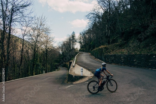 Cyclist climbing corner on mountain road
