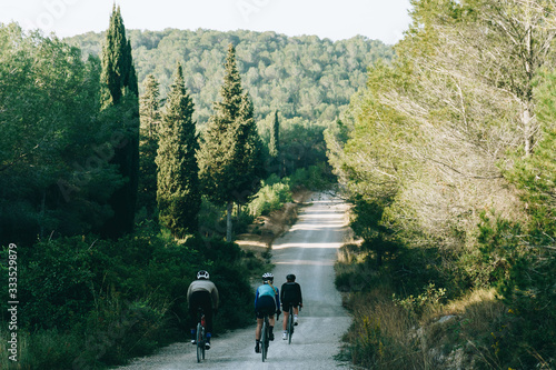 Cyclists on a country gravel road in spain photo