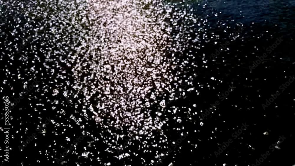 Black and white flowing water and sunbeams, slow motion Black and white flowing water and sunbeams, slow motion