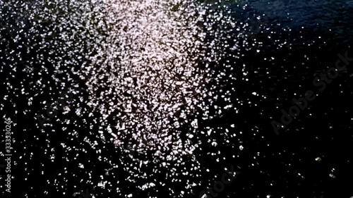 Black and white flowing water and sunbeams, slow motion