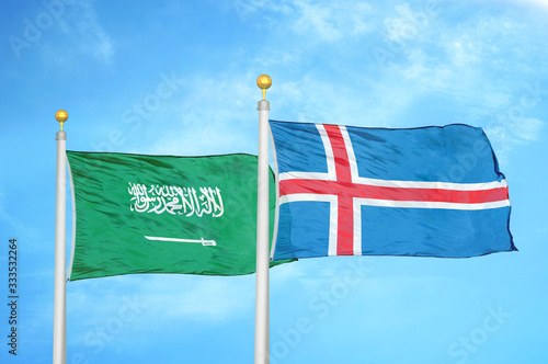 Saudi Arabia and Iceland two flags on flagpoles and blue cloudy sky