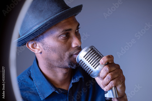 Canvas Print Portrait of a hipster attractive black man singing a vintage song
